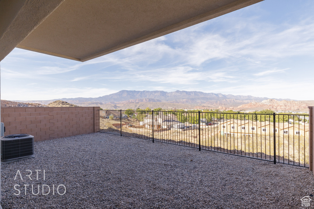 View of yard with central AC and a mountain view