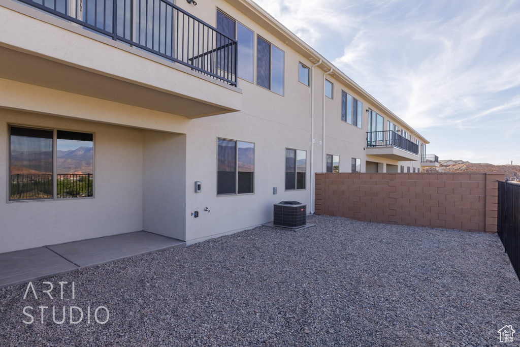 View of side of property featuring a patio, central AC, and a balcony