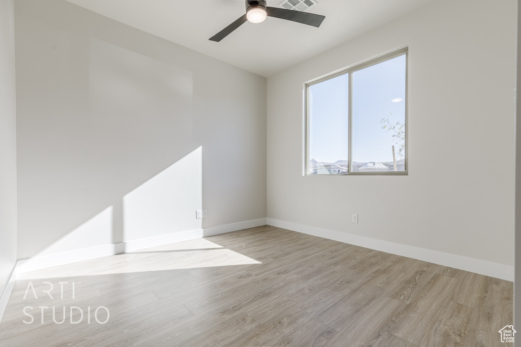 Spare room featuring ceiling fan and light hardwood / wood-style flooring