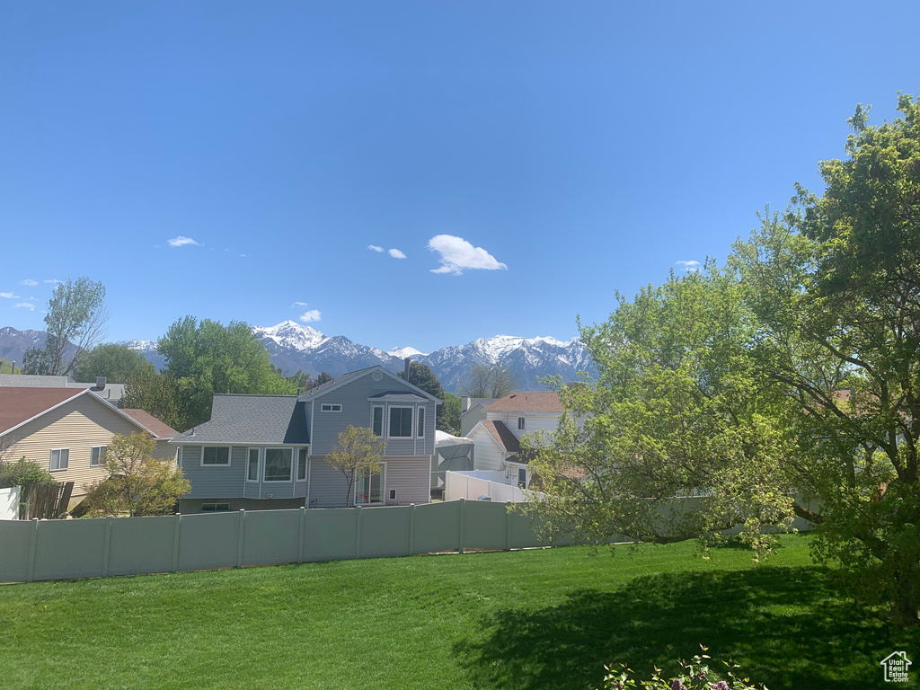 Exterior space featuring a mountain view and a lawn