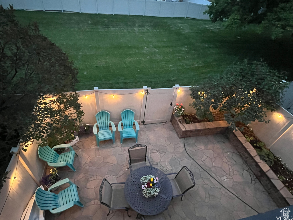Patio terrace at night with a yard