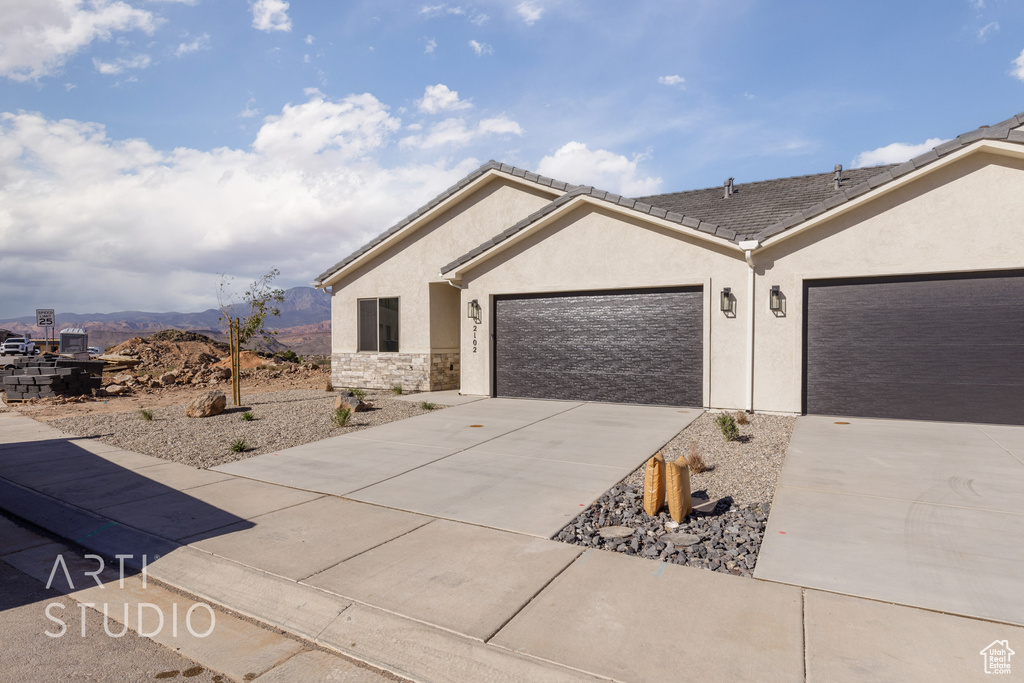 Ranch-style home featuring a mountain view and a garage