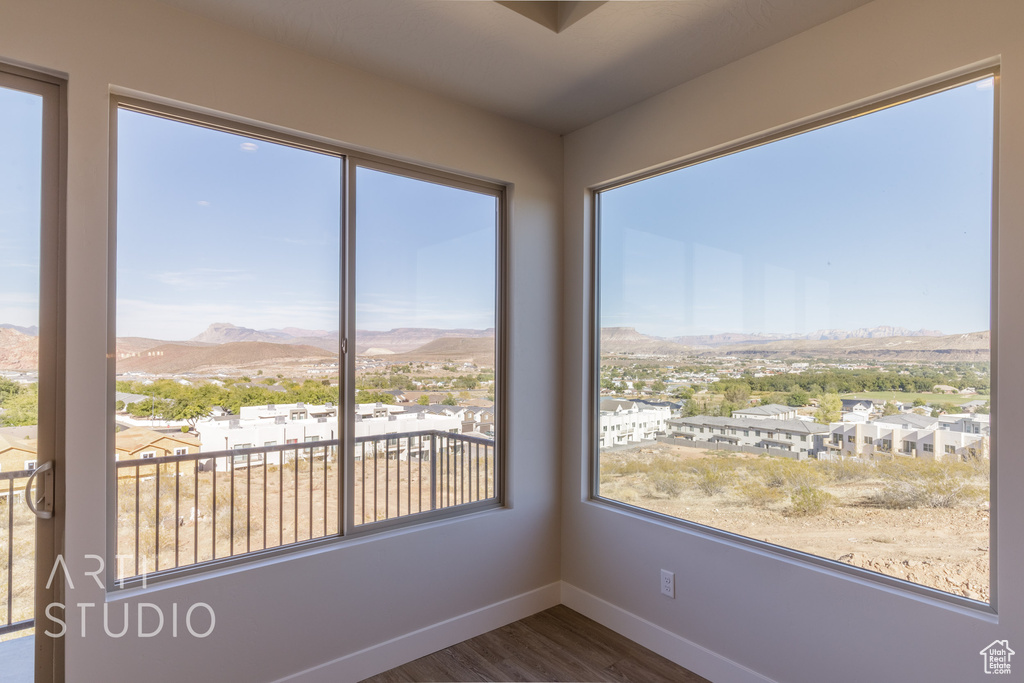 Unfurnished sunroom featuring a mountain view