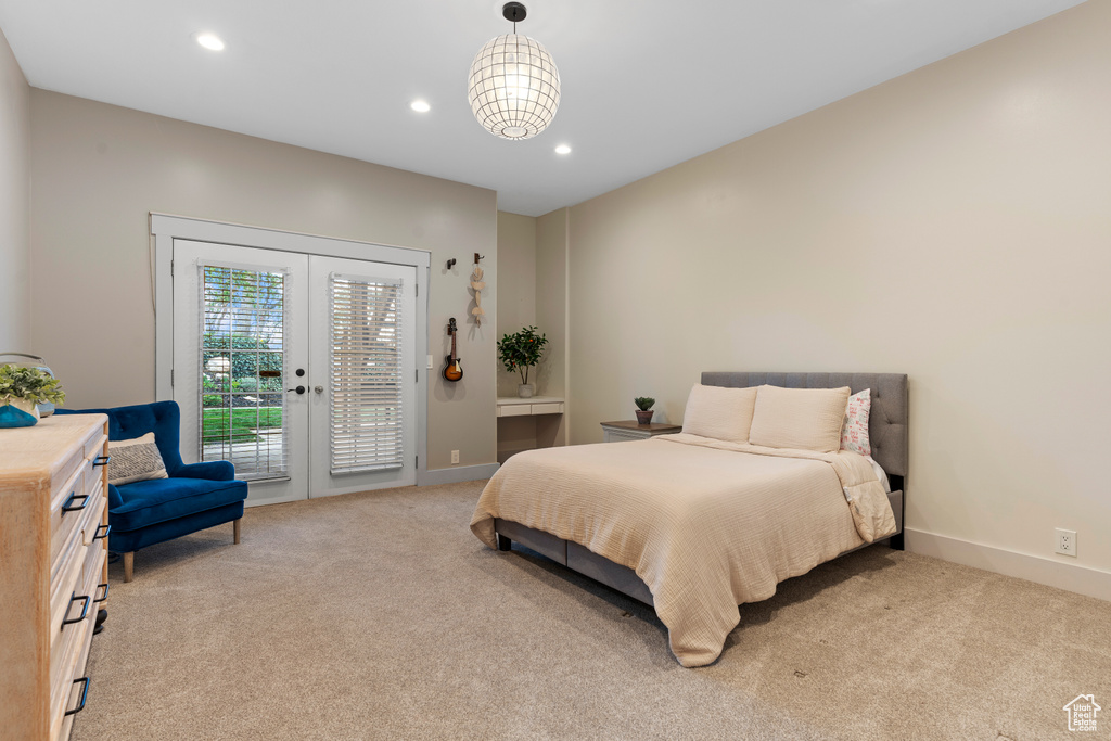 Bedroom featuring light colored carpet, french doors, and access to exterior