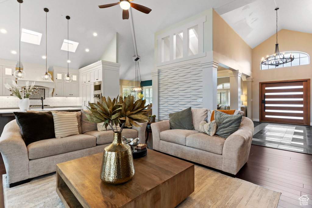 Living room with plenty of natural light, light hardwood / wood-style floors, and high vaulted ceiling