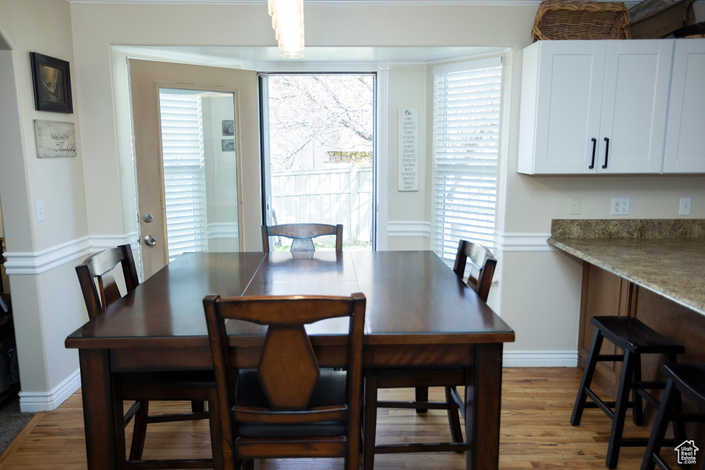 Dining space with hardwood / wood-style flooring