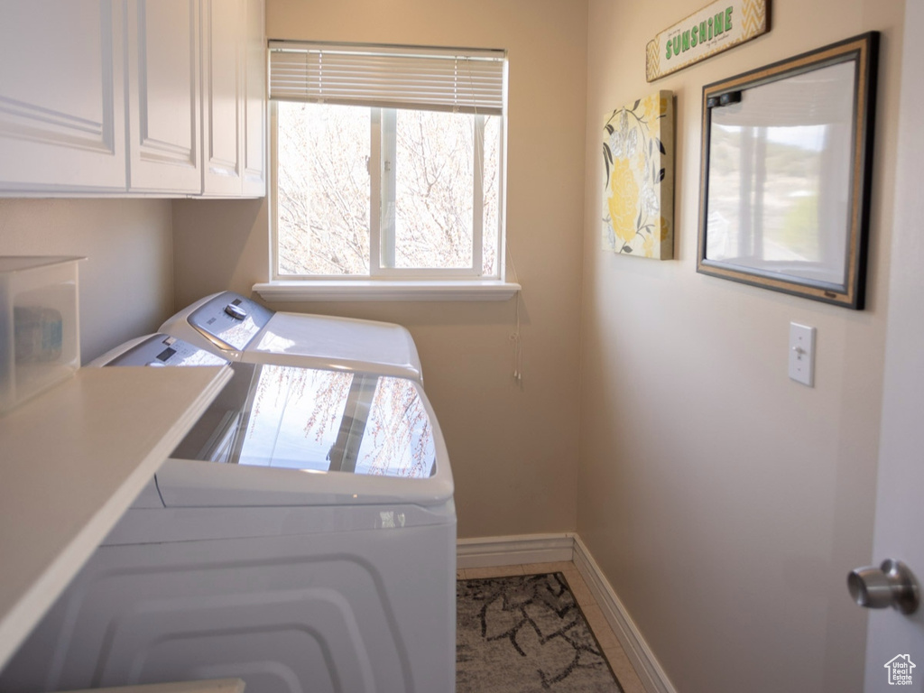 Laundry area featuring cabinets, independent washer and dryer, and ornamental molding