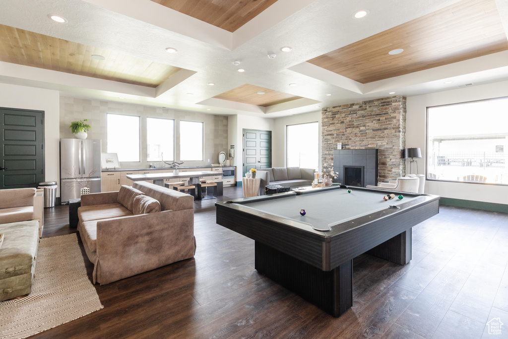 Rec room with dark wood-type flooring, pool table, wooden ceiling, and a tray ceiling