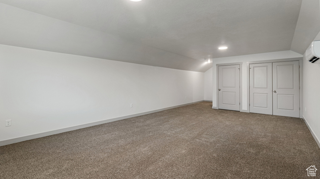 Bonus room featuring carpet floors and vaulted ceiling