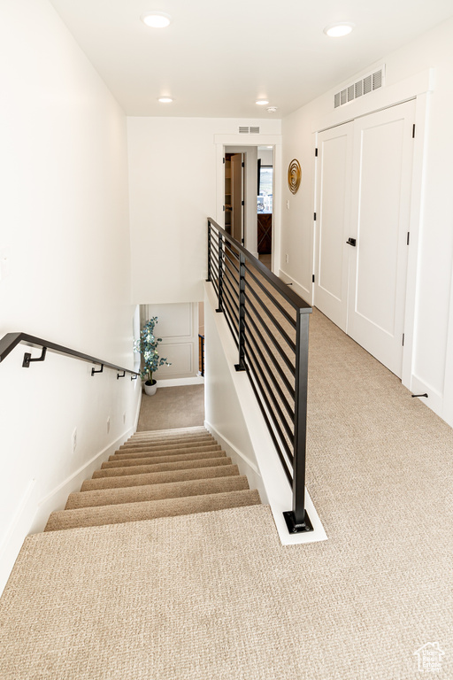 Stairs with light colored carpet