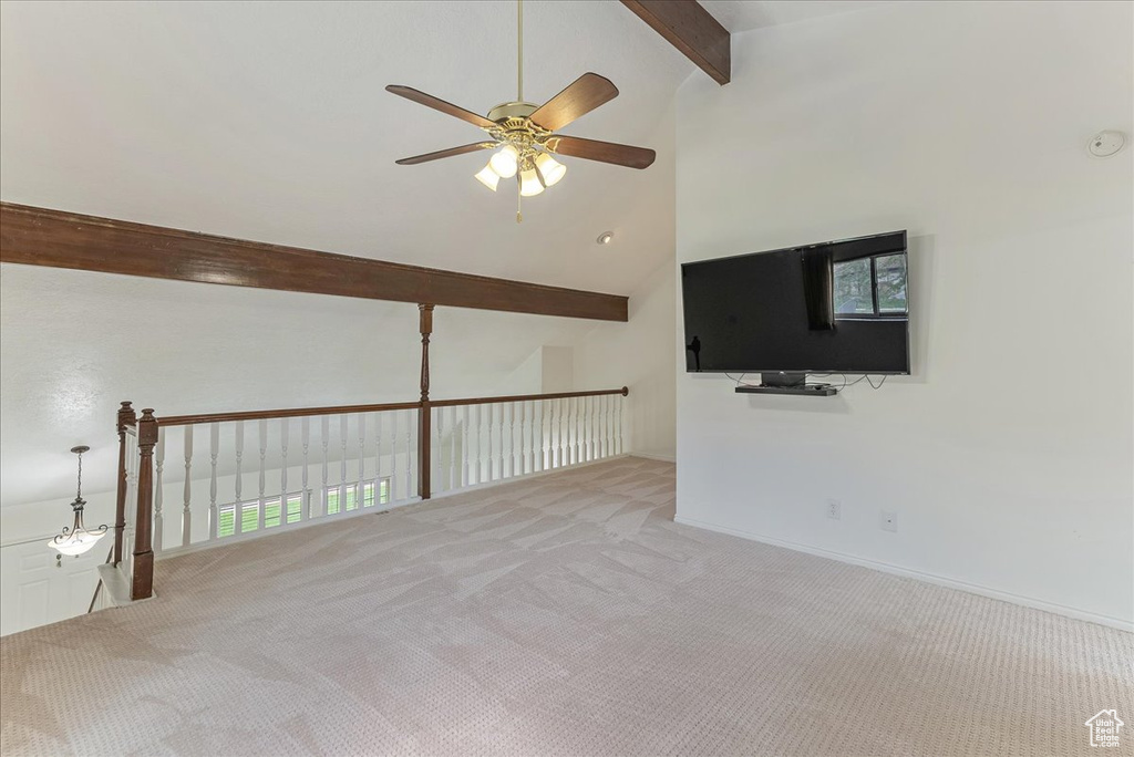 Spare room with carpet flooring, high vaulted ceiling, beamed ceiling, and ceiling fan