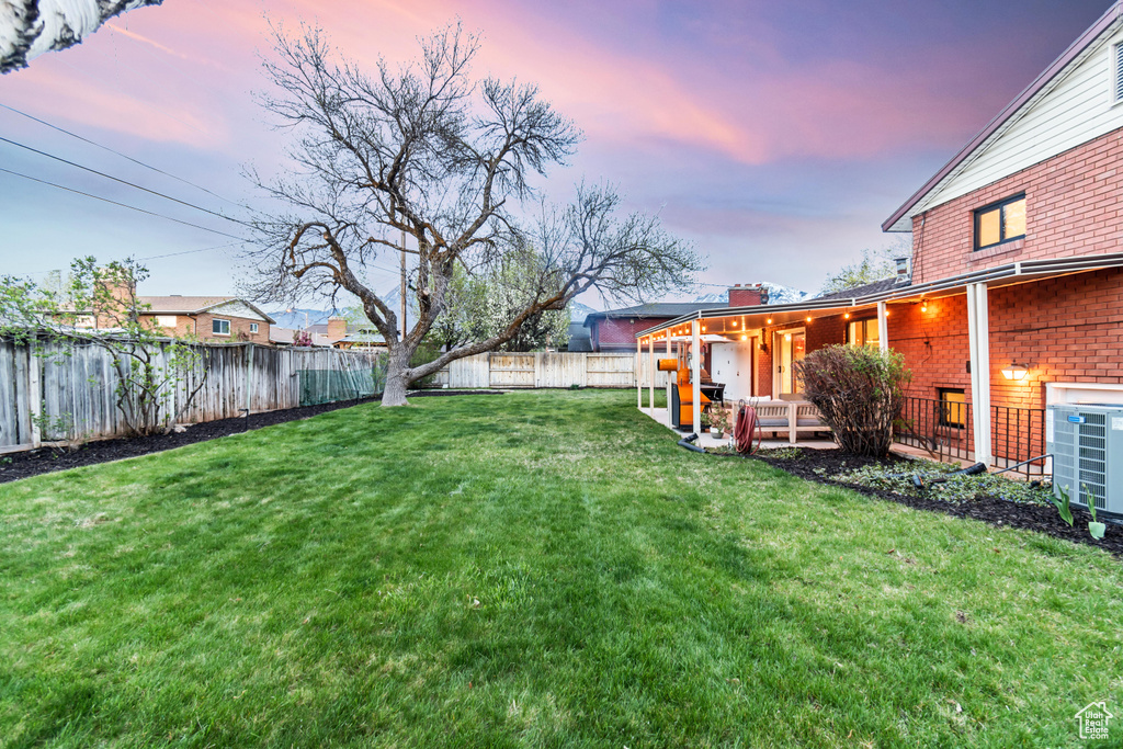 Yard at dusk with a wooden deck