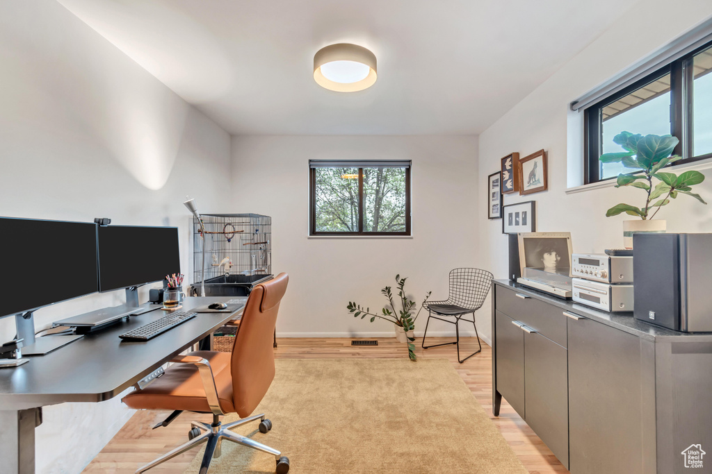 Office area with light wood-type flooring