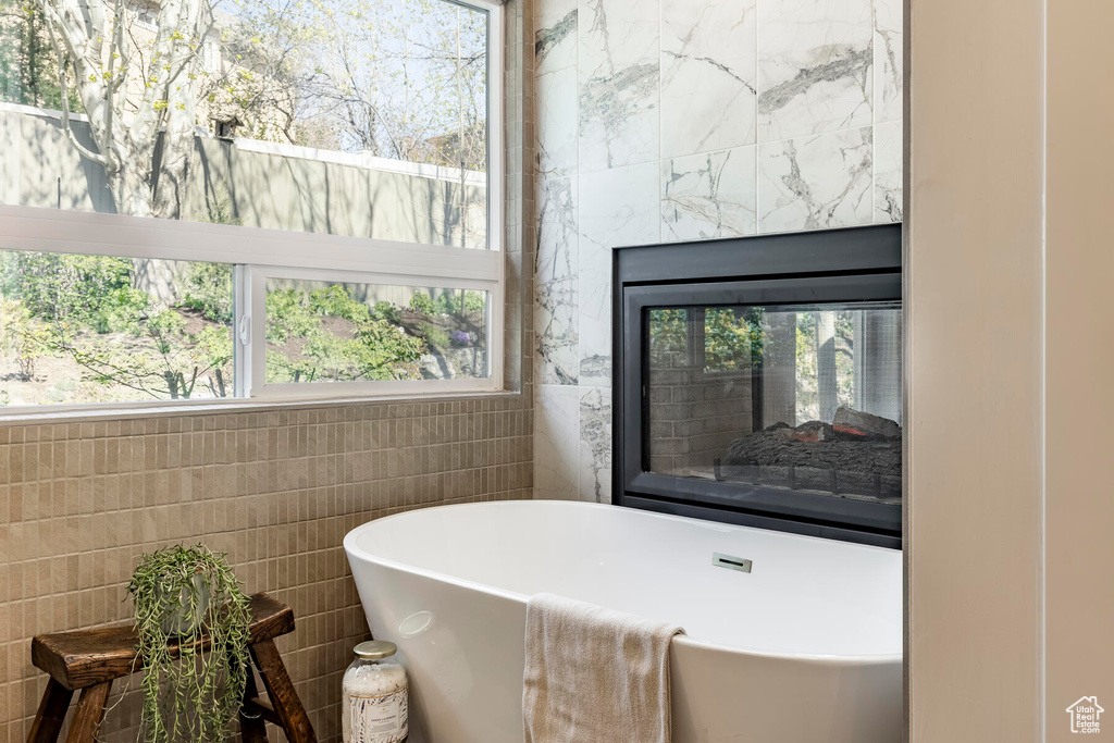 Bathroom featuring tile walls and a wealth of natural light