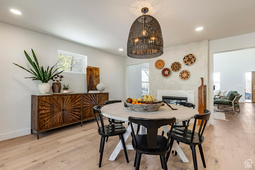 Dining room featuring light hardwood / wood-style floors and an inviting chandelier