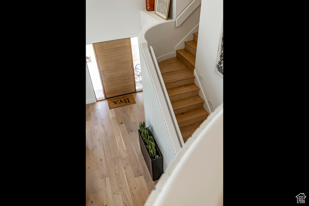 Stairway featuring light hardwood / wood-style floors