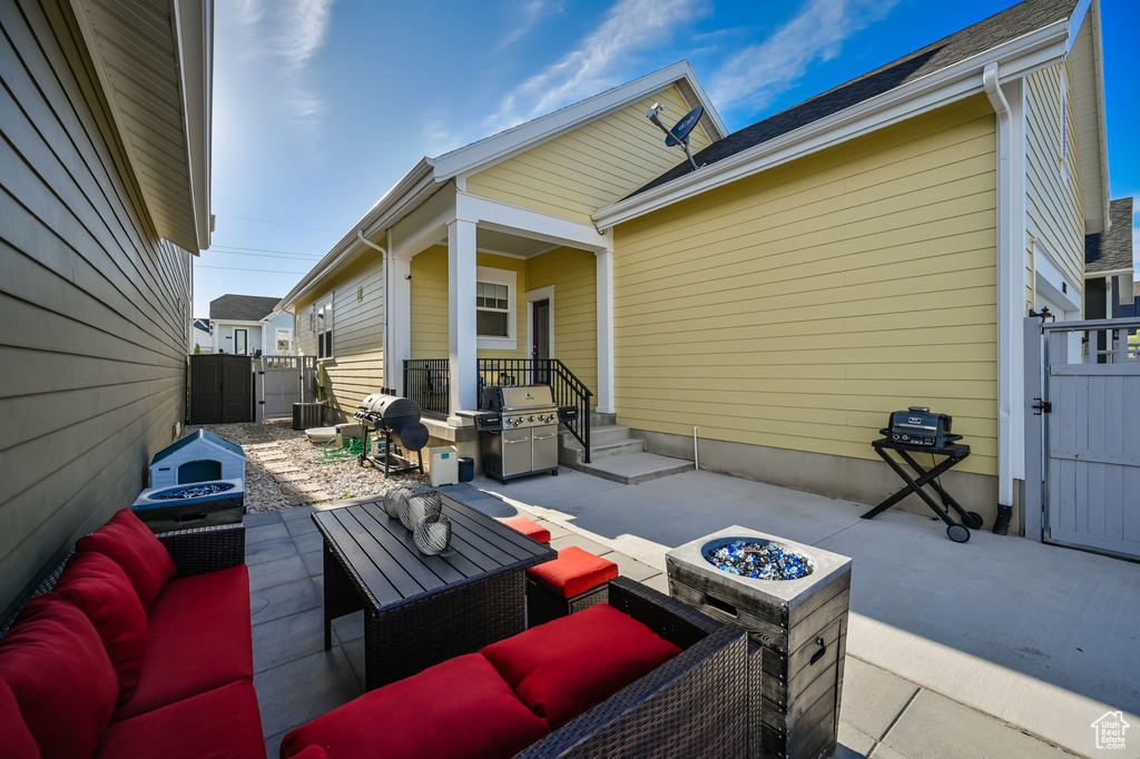 View of patio / terrace featuring area for grilling and an outdoor living space with a fire pit