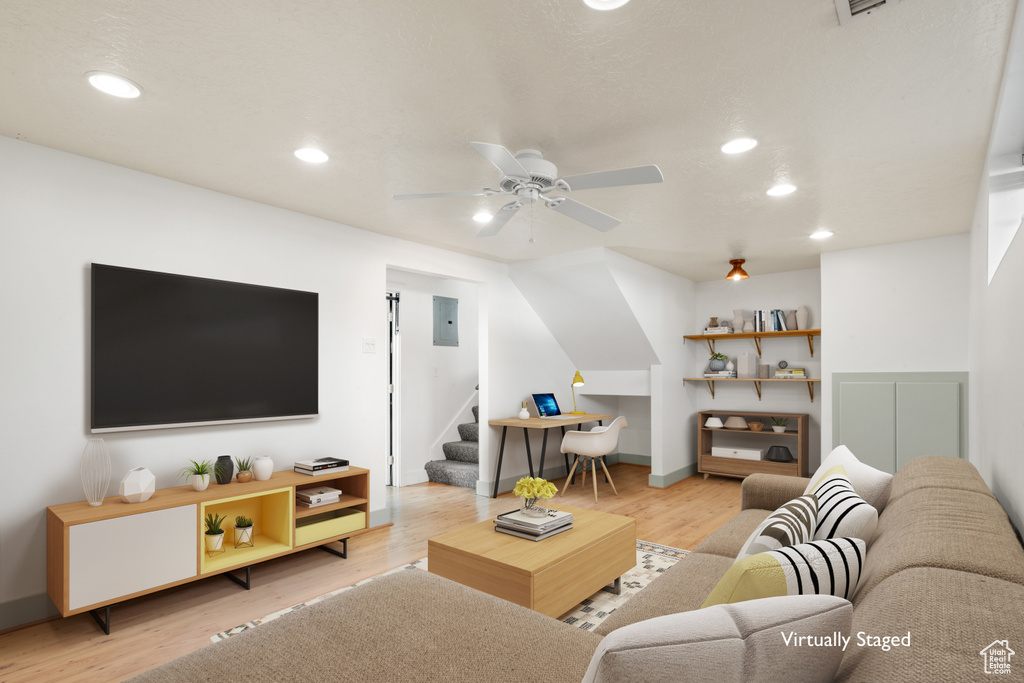 Living room featuring ceiling fan and light wood-type flooring