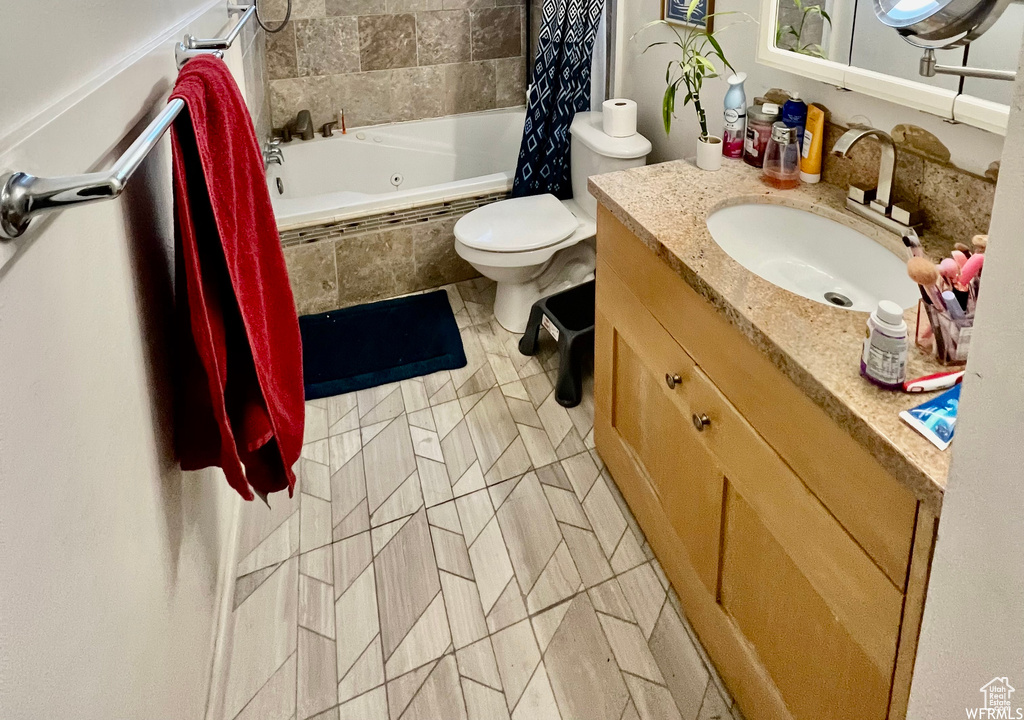 Bathroom featuring oversized vanity, toilet, and tile flooring