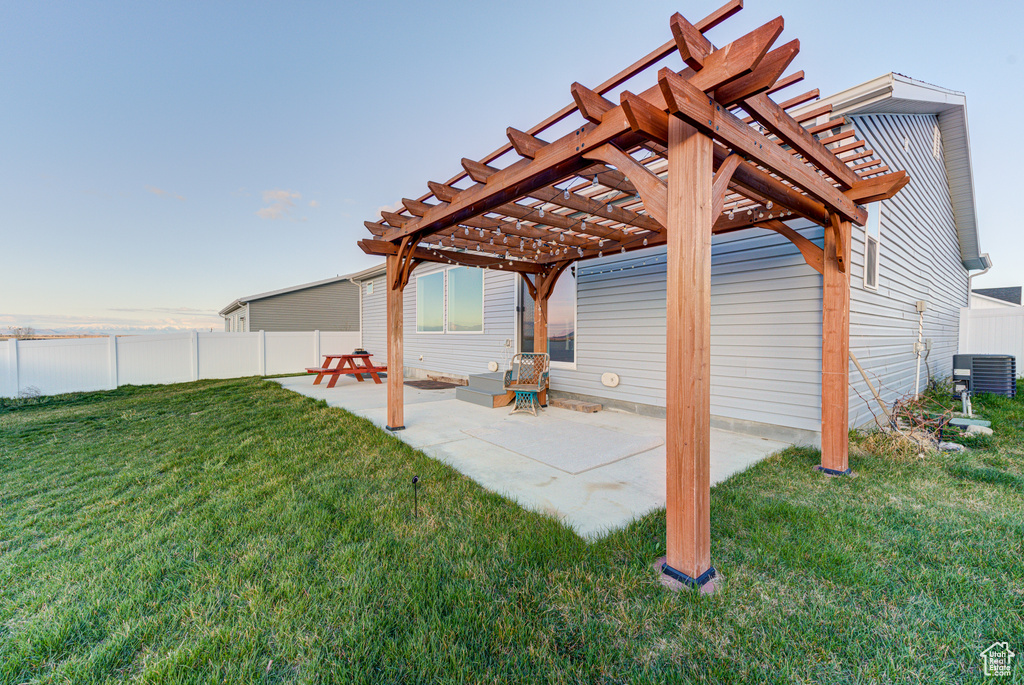 View of yard with a patio, a pergola, and central AC
