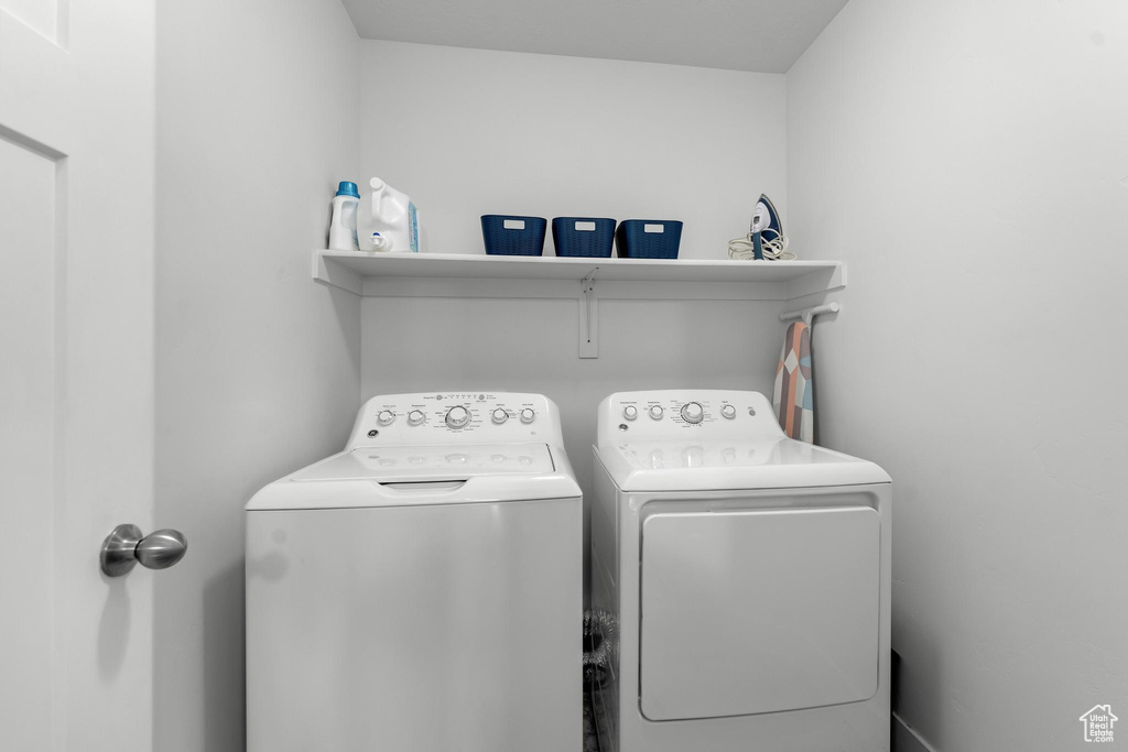 Clothes washing area featuring washing machine and clothes dryer