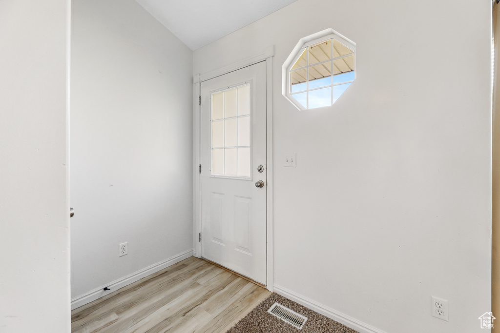 Doorway to outside with light wood-type flooring