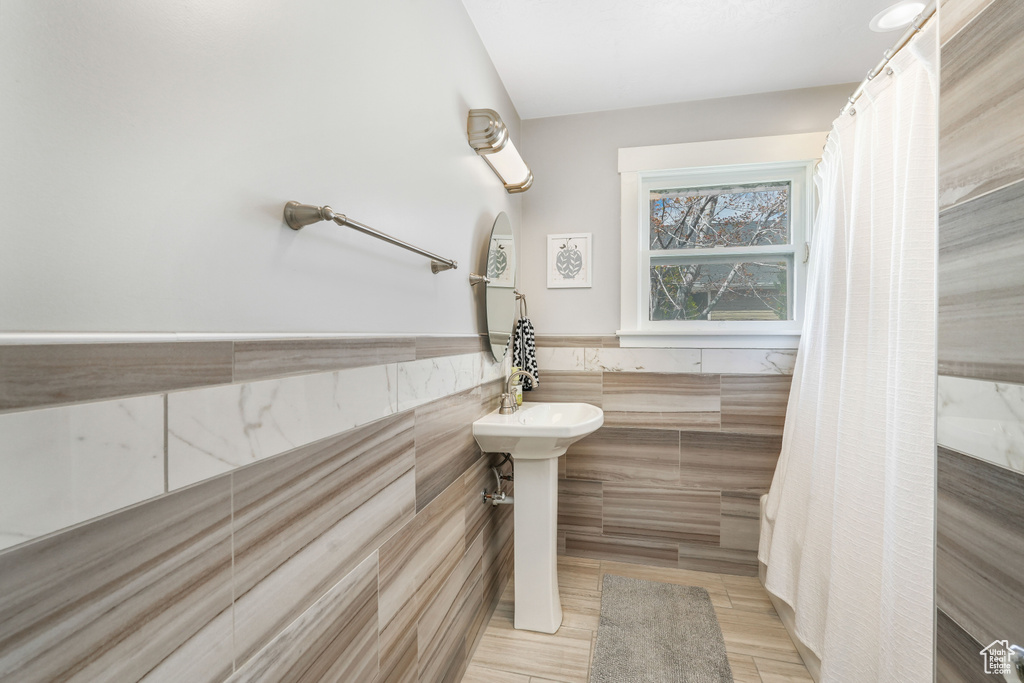 Bathroom featuring tile walls