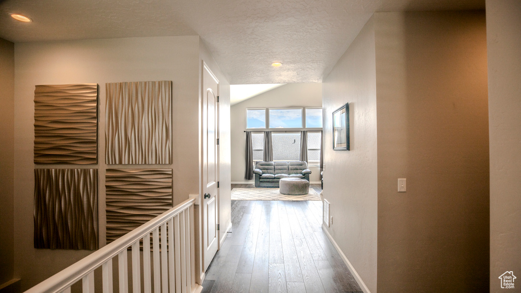 Hallway featuring hardwood / wood-style flooring and a textured ceiling