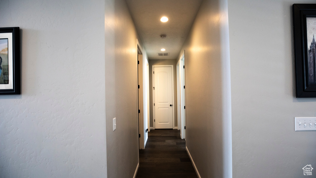 Hallway featuring dark wood-type flooring