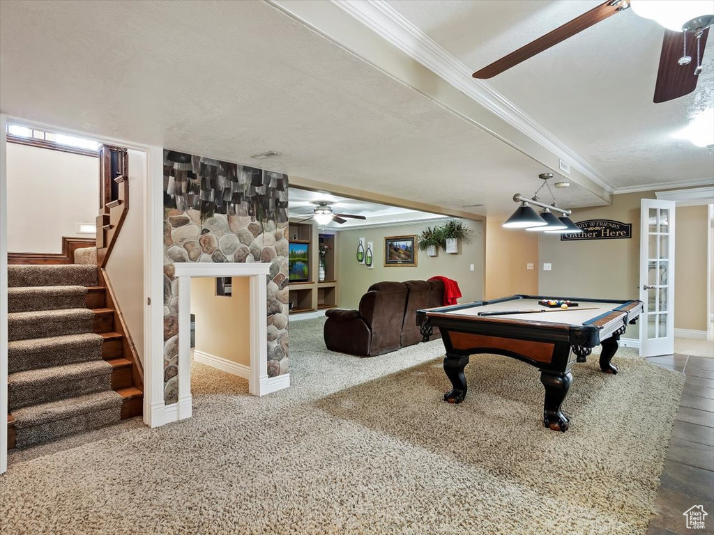 Game room featuring tile flooring, ceiling fan, a fireplace, pool table, and ornamental molding