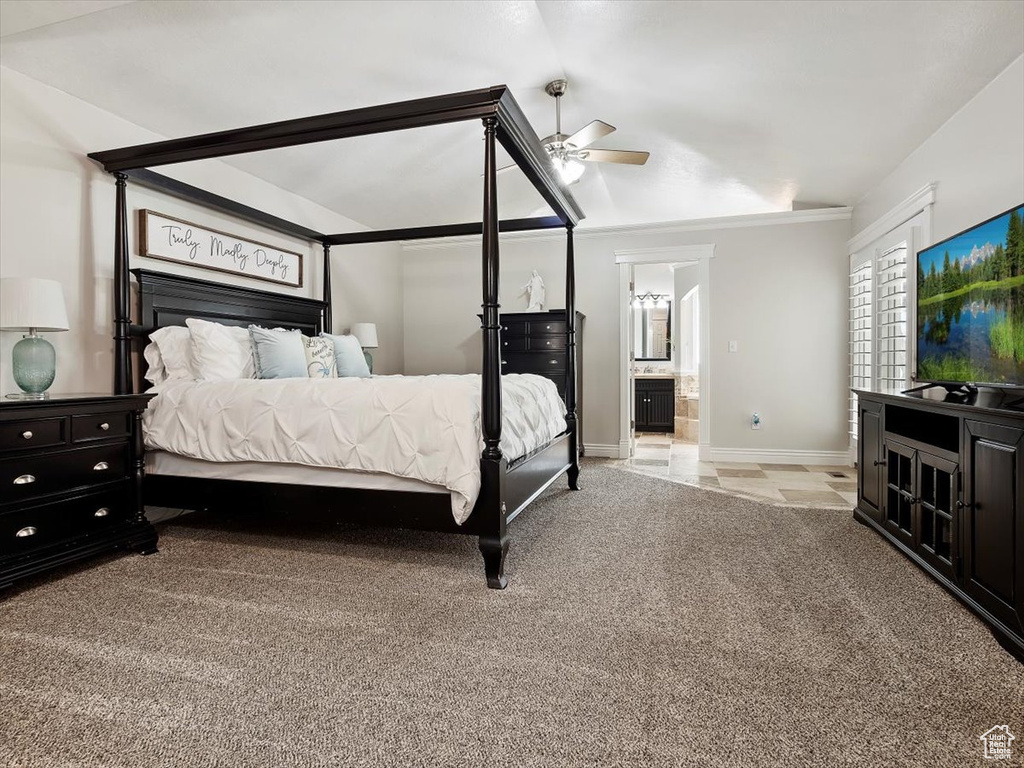 Bedroom featuring light carpet, ceiling fan, and ensuite bath