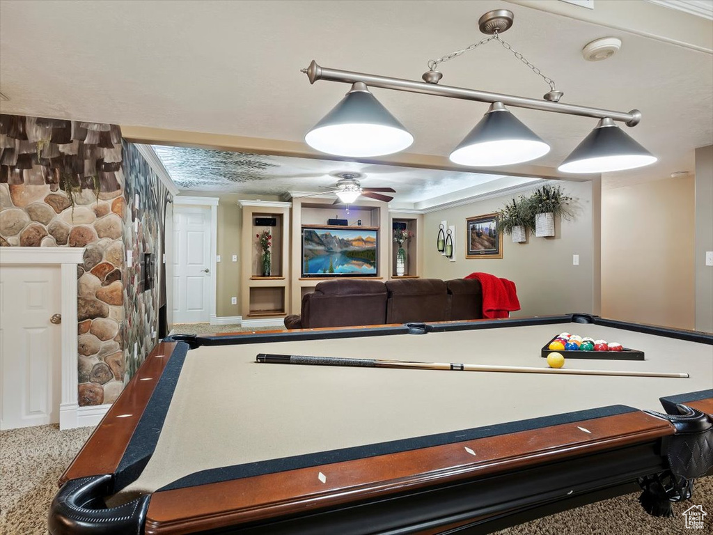 Recreation room featuring a stone fireplace, carpet, ceiling fan, and billiards