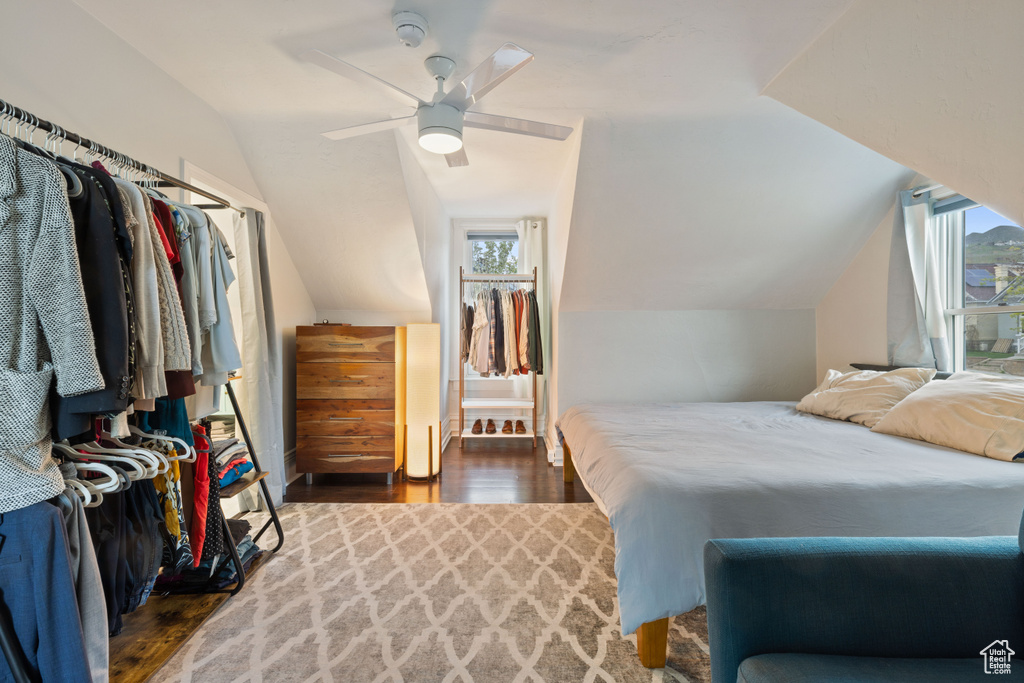 Bedroom featuring dark hardwood / wood-style floors, ceiling fan, and lofted ceiling