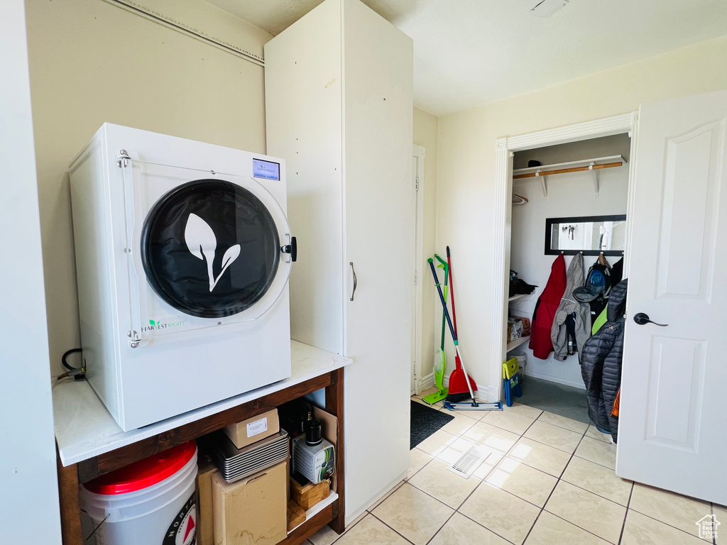 Laundry room featuring washer / clothes dryer and light tile floors