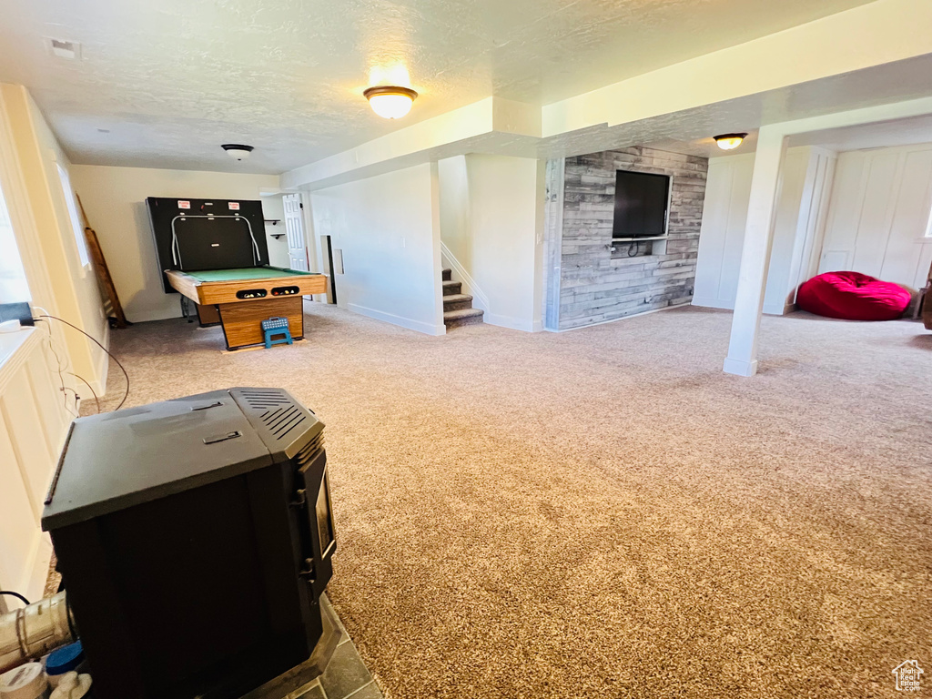 Rec room featuring a textured ceiling, billiards, and light carpet