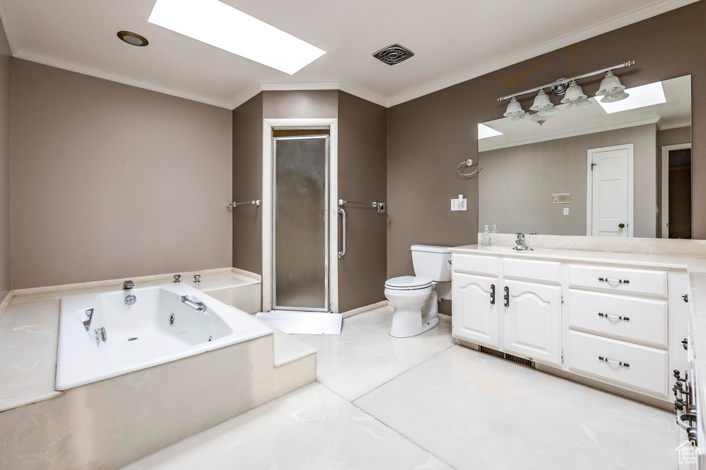 Full bathroom with a skylight, tile flooring, large vanity, shower with separate bathtub, and toilet