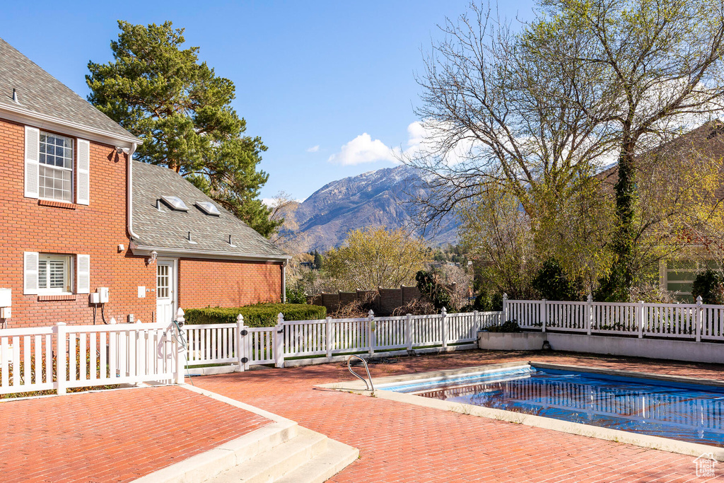 View of pool with a deck with mountain view