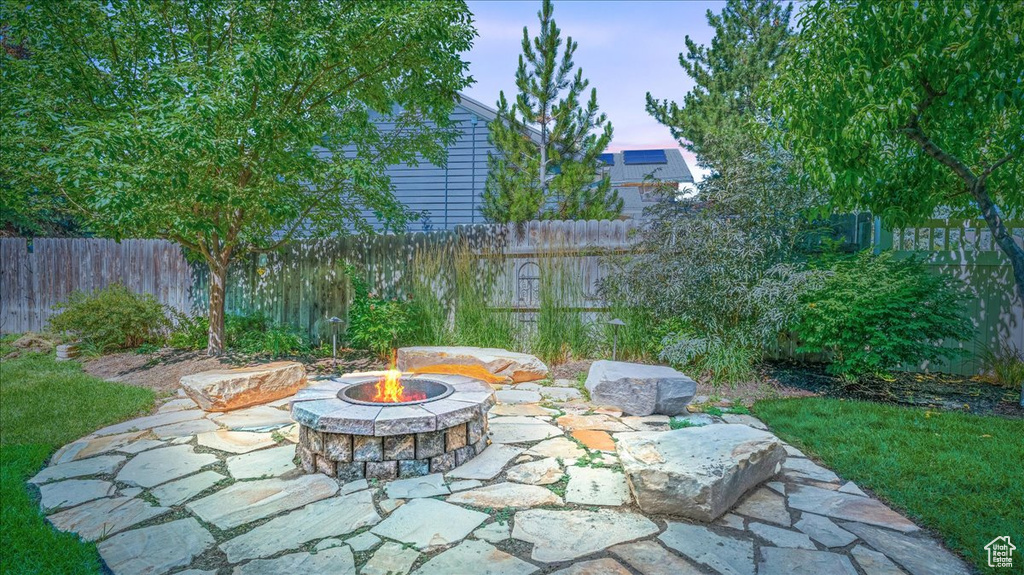 Patio terrace at dusk featuring a fire pit