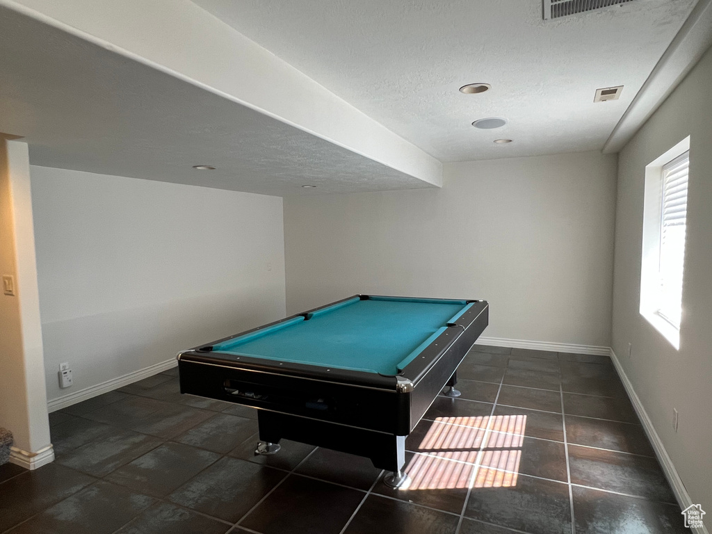 Rec room with dark tile floors and billiards