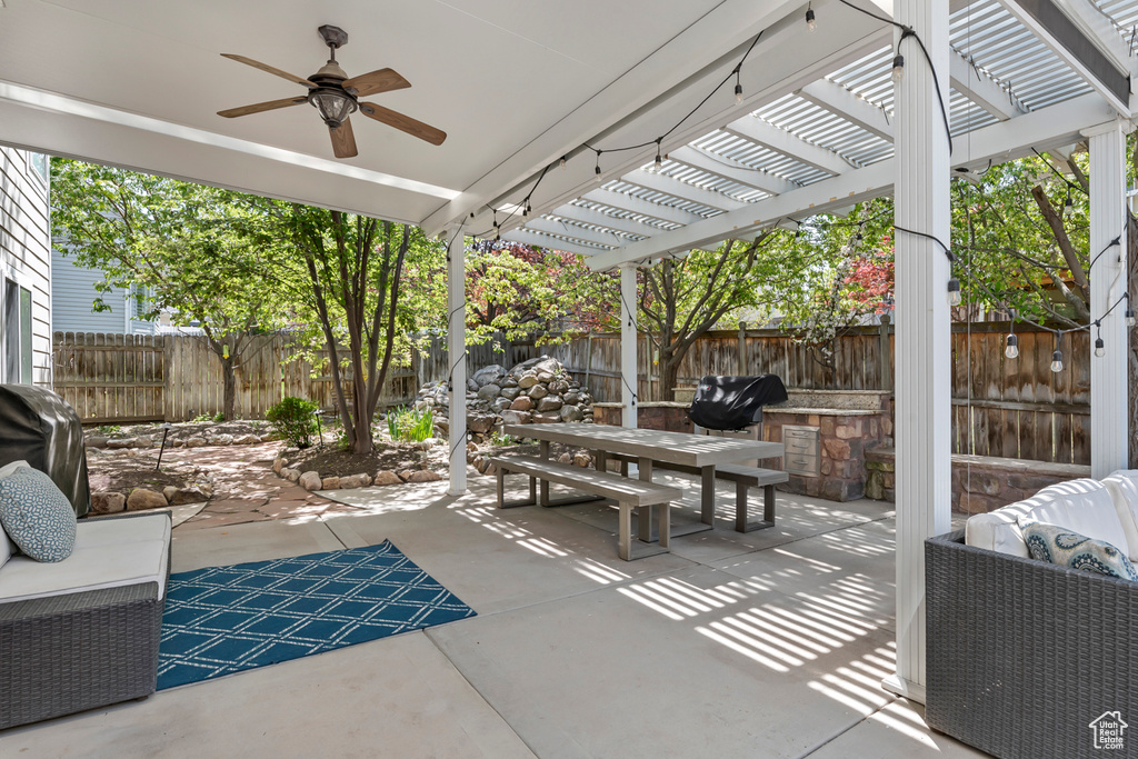 View of patio / terrace featuring a grill, ceiling fan, and a pergola