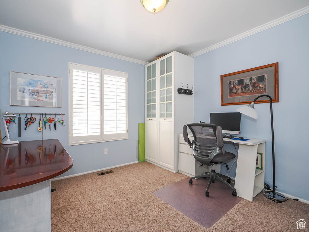 Home office featuring light colored carpet and crown molding