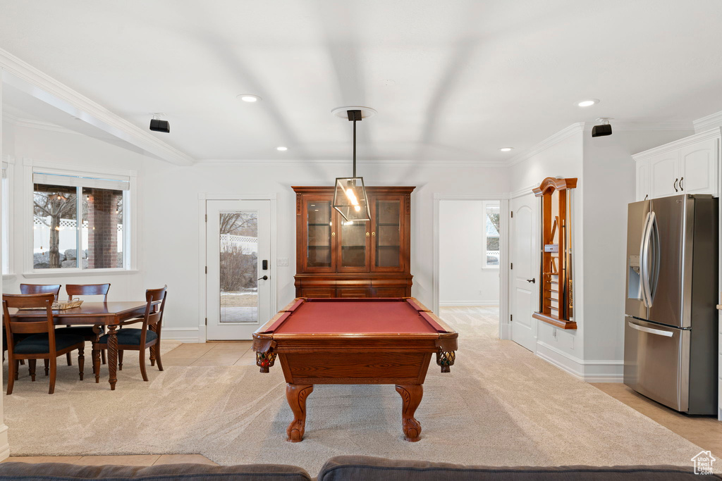 Game room featuring a wealth of natural light, ornamental molding, light colored carpet, and pool table
