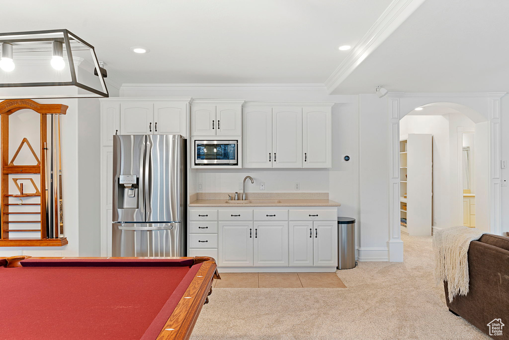 Game room with crown molding, light colored carpet, pool table, and sink