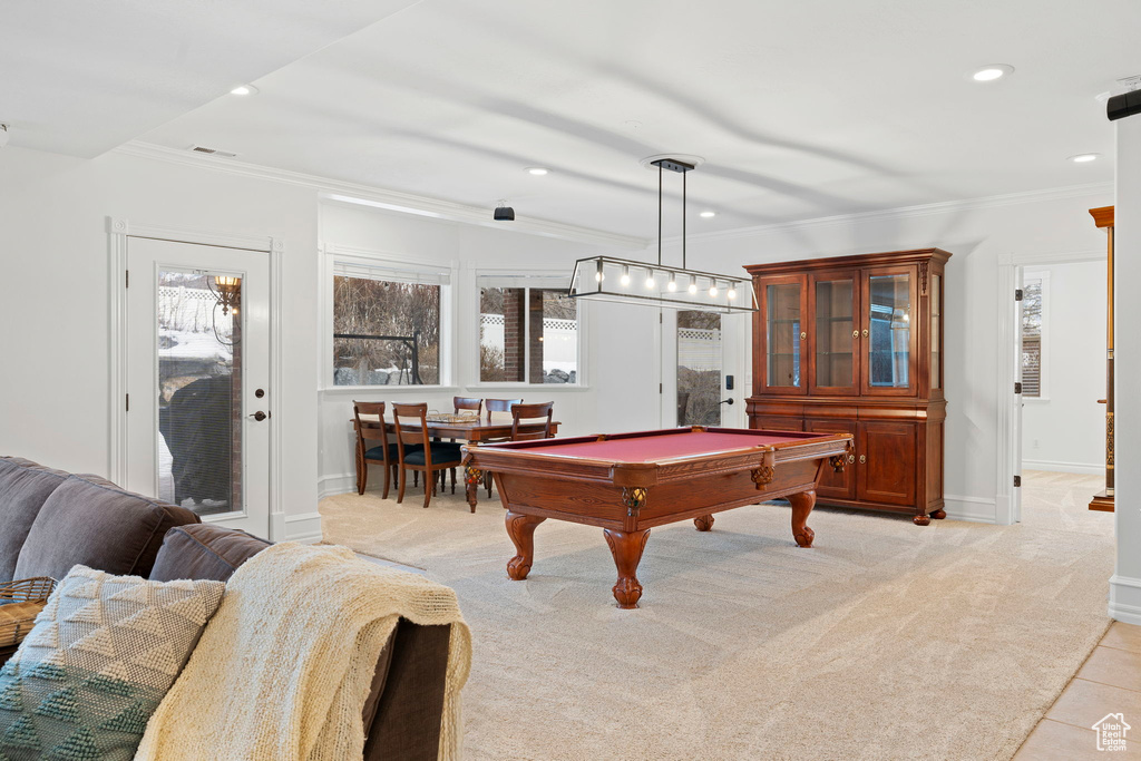 Game room featuring ornamental molding, light tile flooring, and billiards