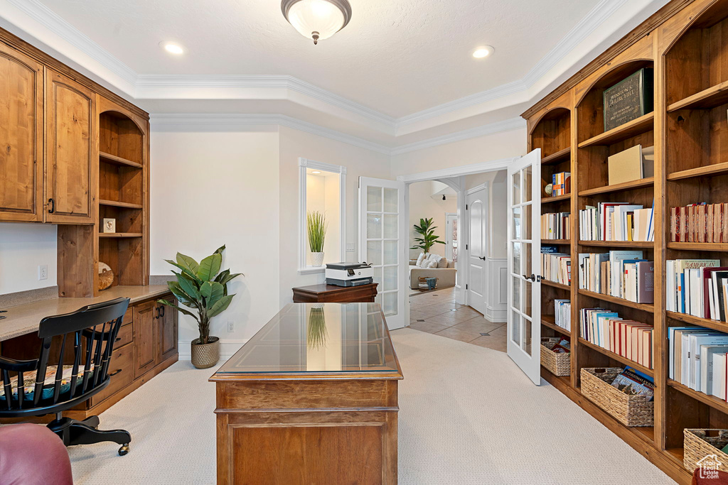 Carpeted office space featuring crown molding