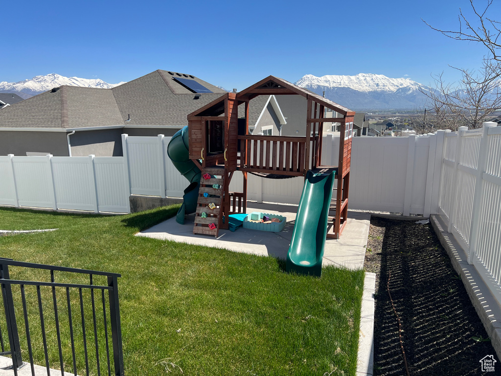 View of yard featuring a mountain view and a playground