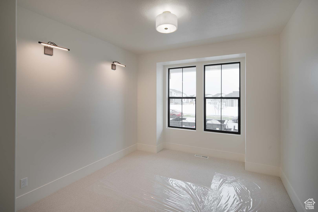 Unfurnished room featuring carpet flooring