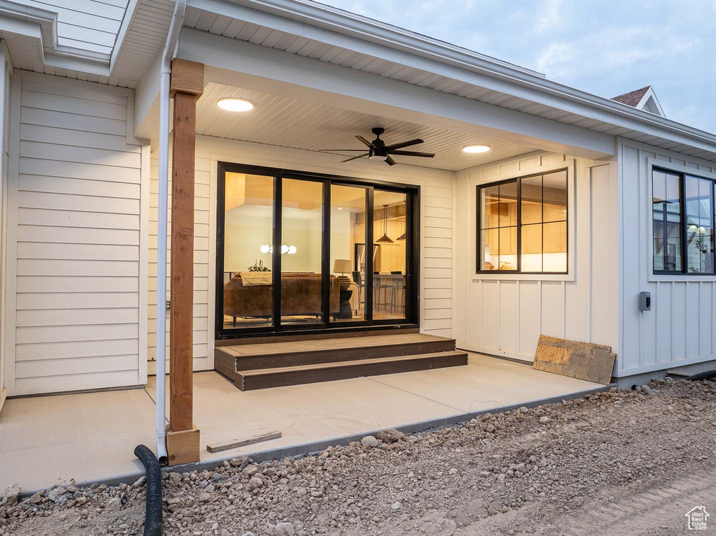 Entrance to property with ceiling fan and a patio