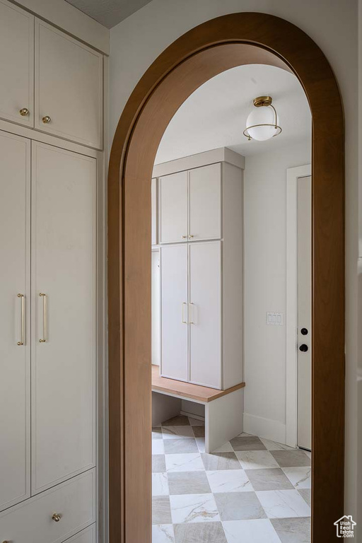 Corridor with light tile patterned floors