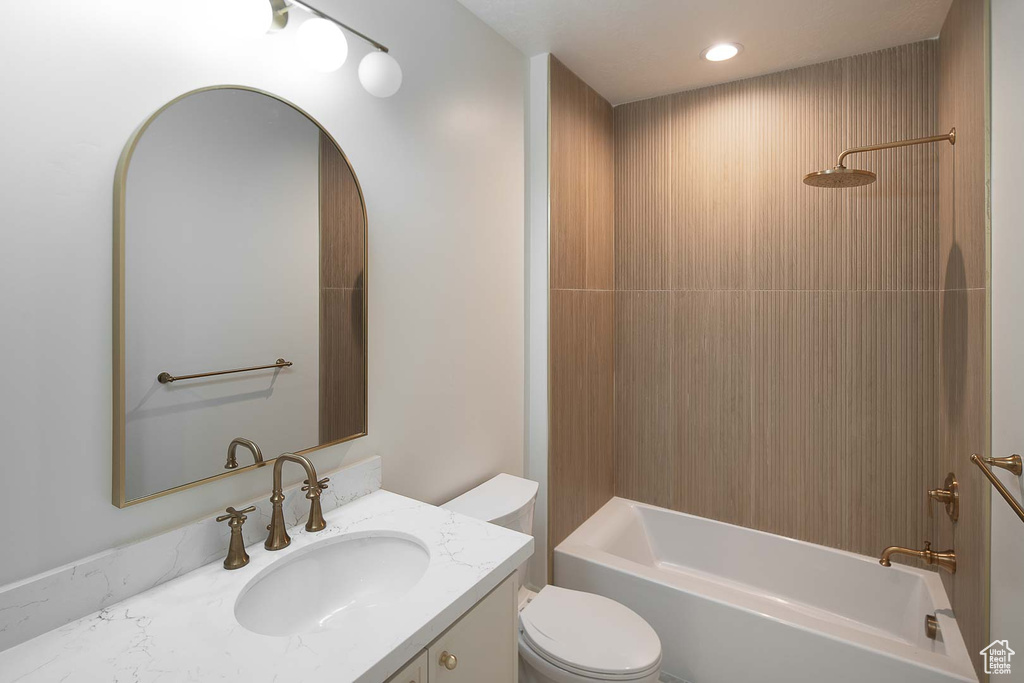 Full bathroom featuring vanity, toilet, and shower / tub combination